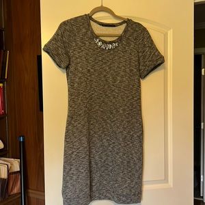 Knit dress with pockets and jewel embellishment.